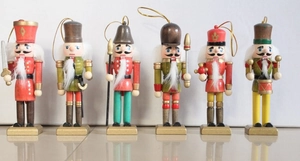 Close-up of 6-piece wooden nutcracker set with hanging strings and colorful paint