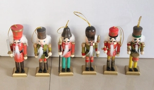 Detail view of 6-piece wooden nutcracker soldier set with gold lanyards and vibrant paint