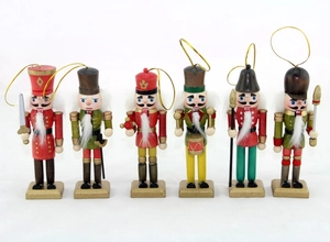 Detailed view of six hand-painted wooden nutcracker soldier ornaments with gold hanging strings