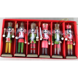 Set of six wooden Nutcracker soldier ornaments in red and green festive uniforms