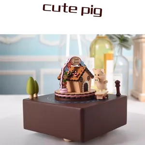Handcrafted wooden music box featuring a cute pig on skateboard and a candy house model