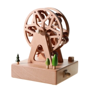 Handcrafted wooden ferris wheel music box with miniature trees on a natural wood base