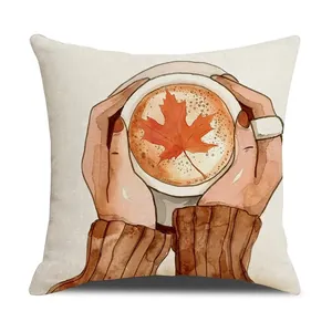 Linen autumn throw pillow cover featuring watercolor hands holding maple leaf coffee art