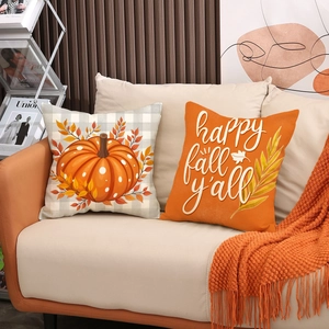 Fall pumpkin and 'Happy Fall Y'all' linen pillow covers set on a beige sofa