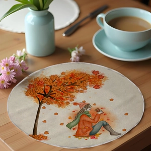 Close-up of autumn harvest round linen placemat with maple tree and girl illustration
