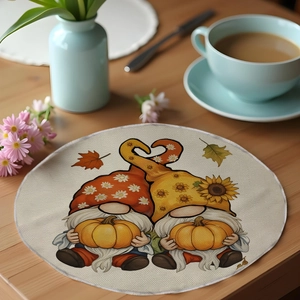 Linen placemat detail with autumn gnomes and pumpkin design on a wooden table