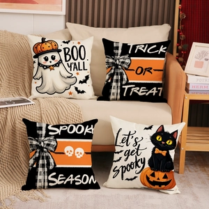 Set of four Halloween pillow covers with ghost and pumpkin prints on a beige sofa