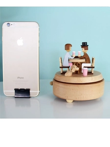 Detailed size comparison of a wooden music box featuring a romantic couple and dog figures
