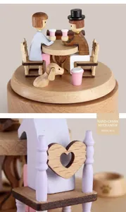 Detail of wooden music box showing a couple dining scene with heart-shaped chair cutouts