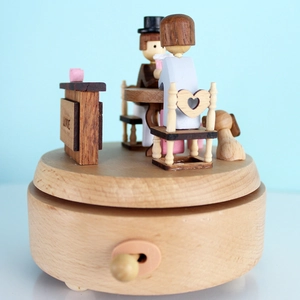 Romantic beech wood music box featuring moving couple and love engraving on round base