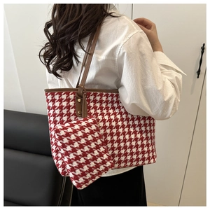 Detailed view of red houndstooth tote bag and mini pouch with premium brown leather straps