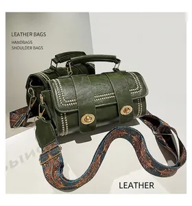 Detail of green vintage barrel bag with golden studs and ethnic patterned strap