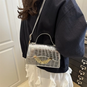 Silver crocodile texture handbag with gold chain detail and adjustable shoulder strap