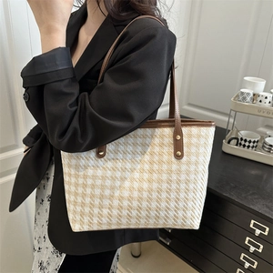 Chic houndstooth tote bag with brown leather handles and gold-tone hardware for women