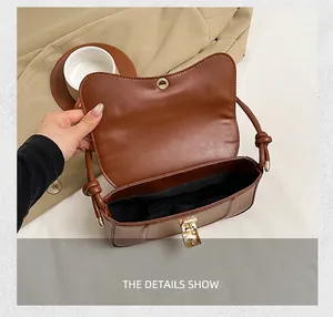 Interior view of the brown leather shoulder bag showing storage space and black lining