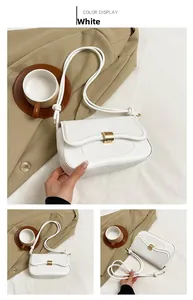 Close-up of white minimalist shoulder bag with golden buckle and curved flap detail