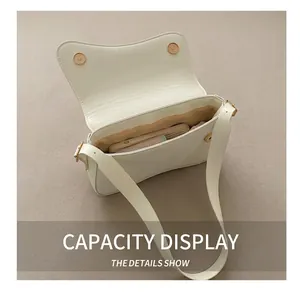 Top view of white saddle bag showing internal capacity with magnetic closure