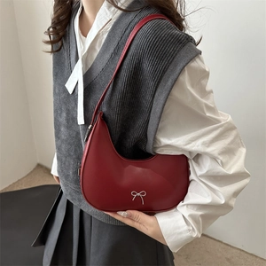 Red crescent leather hobo bag with silver bow charm and adjustable slim shoulder strap