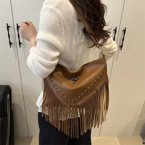 Brown leather bohemian tassel shoulder bag with metallic cross and rivet details