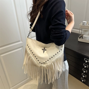 Beige faux leather bohemian shoulder bag with metallic studs and long fringe tassels
