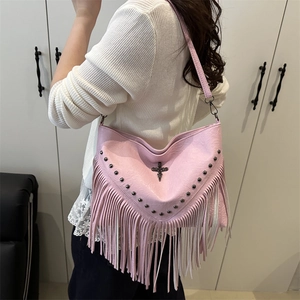 Pink bohemian tassel shoulder bag with studs and cross pendant decoration