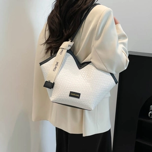 White woven texture tote bag with black trim and wide canvas shoulder strap for women