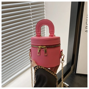 Détail du mini sac seau rose avec doubles fermetures éclair et chaîne dorée