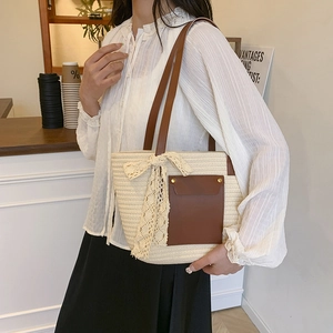 Chic beige woven tote bag with brown leather pocket and elegant lace bow detail