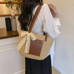 Chic beige woven tote bag with brown leather straps and white lace bow decoration