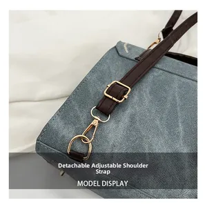 Detail of adjustable and detachable brown leather strap with gold metal lobster clasp