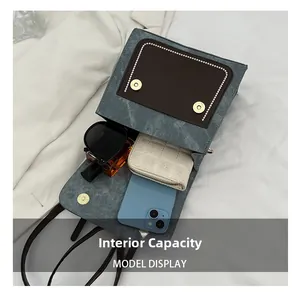 Detail view of the retro crossbody bag interior showing space for phone and essentials