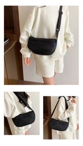 Detailed views of a black canvas crossbody bag with blue tag and adjustable strap