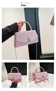 Detail of pink leather handbag featuring sparkling rhinestones and silver A-shape clasp