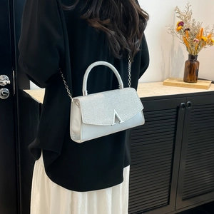 Elegant silver glitter evening clutch bag with metal handle and chain strap for women