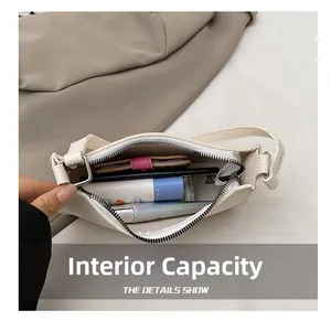 Internal capacity of white lychee leather hobo bag showing daily essentials with zipper