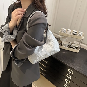 Silver snakeskin pattern PU leather tote bag worn as a shoulder bag by a female model
