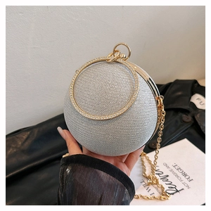 Detail of silver spherical evening clutch bag with diamond circular handle and chain