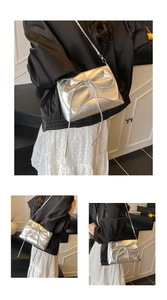 Close-up of silver ballet-style crossbody bag with large bow and elegant chain strap