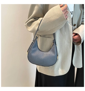 Blue-grey textured hobo shoulder bag with vertical stripes and golden zipper hardware