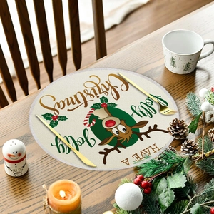 Round linen Christmas placemat with cartoon reindeer and festive holly on wooden table
