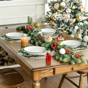 Detailed view of four circular Christmas placemats with hand-drawn forest pattern on wood