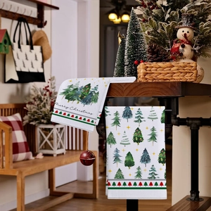Detail of waffle weave Christmas kitchen towels with festive green tree prints