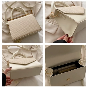 Detail view of cream PU leather handbag with woven flap, bottom corners, and interior space