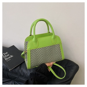 Detail of neon green and herringbone shell bag with Fashion & Bags embossing