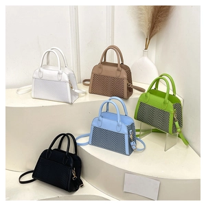 Detail of five multi-colored crossbody bags with herringbone weave and faux leather finish