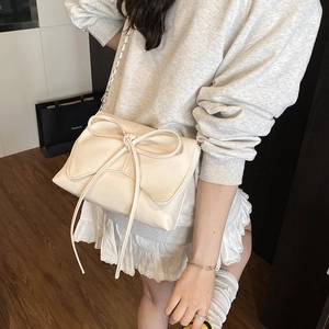 Chic off-white ballet style shoulder bag with large bow and elegant chain strap