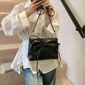 Chic black ballet style shoulder bag with large bow and elegant metal chain strap