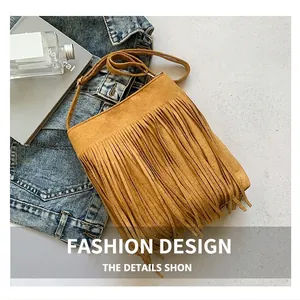 Close-up of vintage brown suede crossbody bag featuring dense fringe tassels and strap