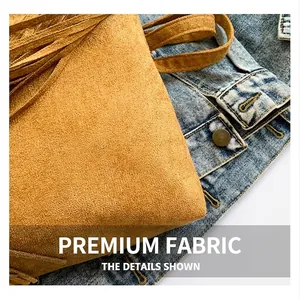 Detail of brown frosted PU leather shoulder bag with vintage fringe and bohemian texture