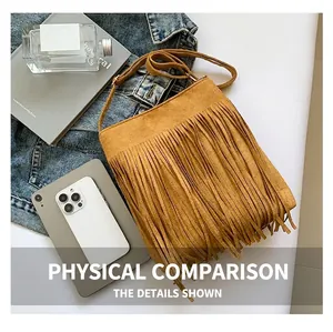 Close-up of bohemian mustard yellow suede crossbody bag with long fringes and strap